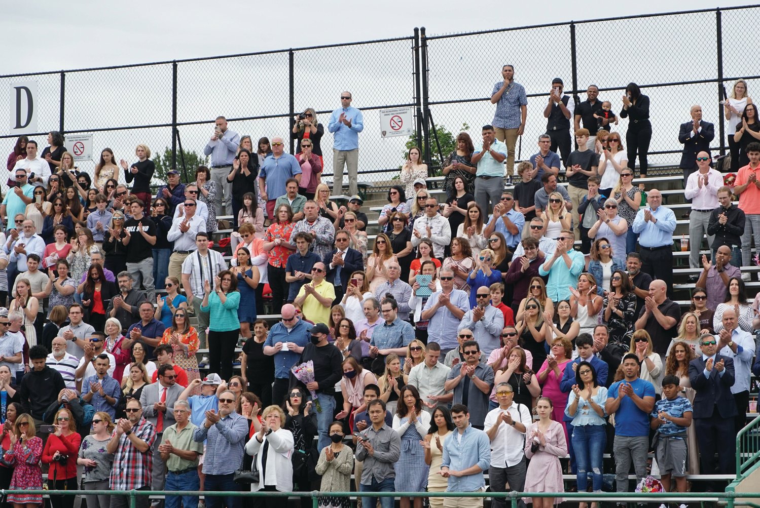 REASON TO CHEER: Parents and loved ones of Cranston West 2021 graduates cheer from the stands of Cranston
Stadium following the Cranston West Choir’s rendition of the national anthem.